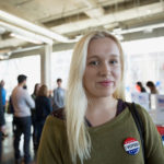 Portrait confident young woman at voter polling place